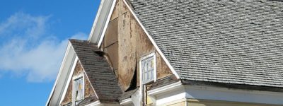 Home with siding damage in need of repair